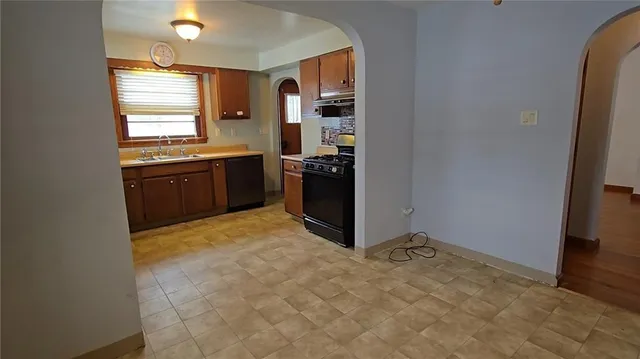 a kitchen with stainless steel appliances granite countertop a refrigerator and a stove