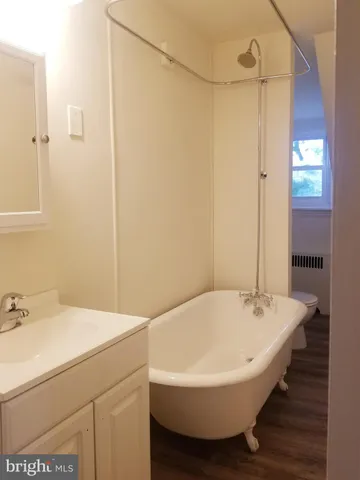 a bathroom with a bathtub and a sink