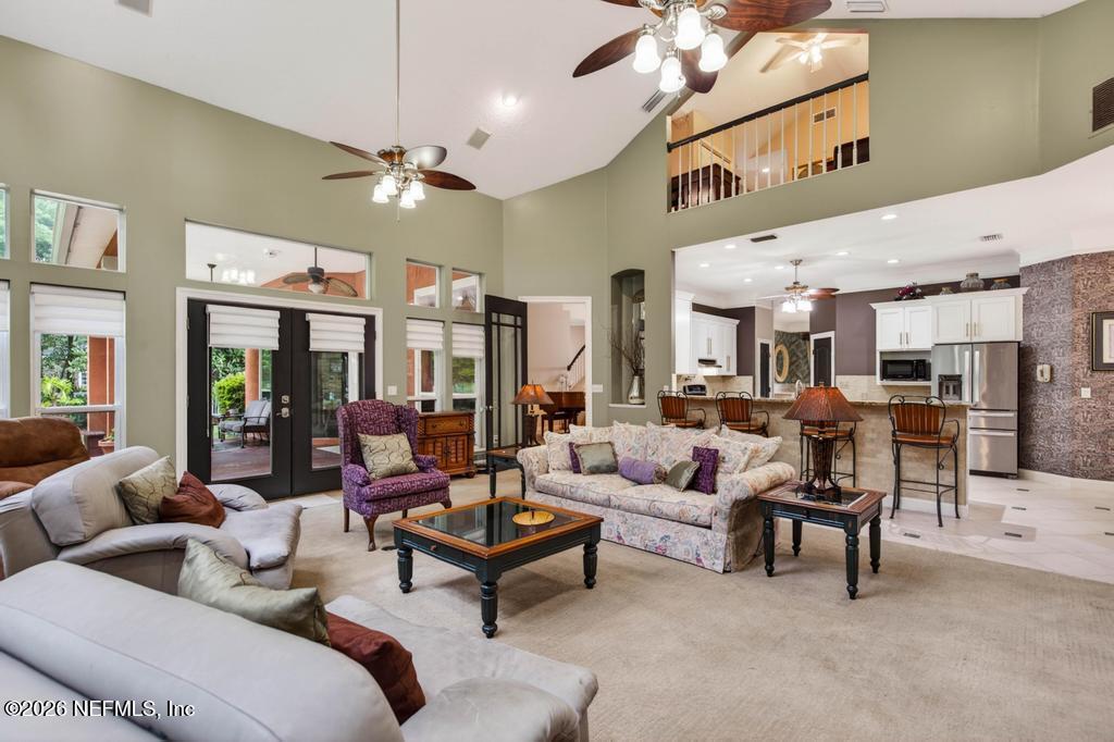 1483 Bridgette Way Fleming Island, FL 32003 - Photo 24 of 63 a living room with furniture kitchen view and a chandelier