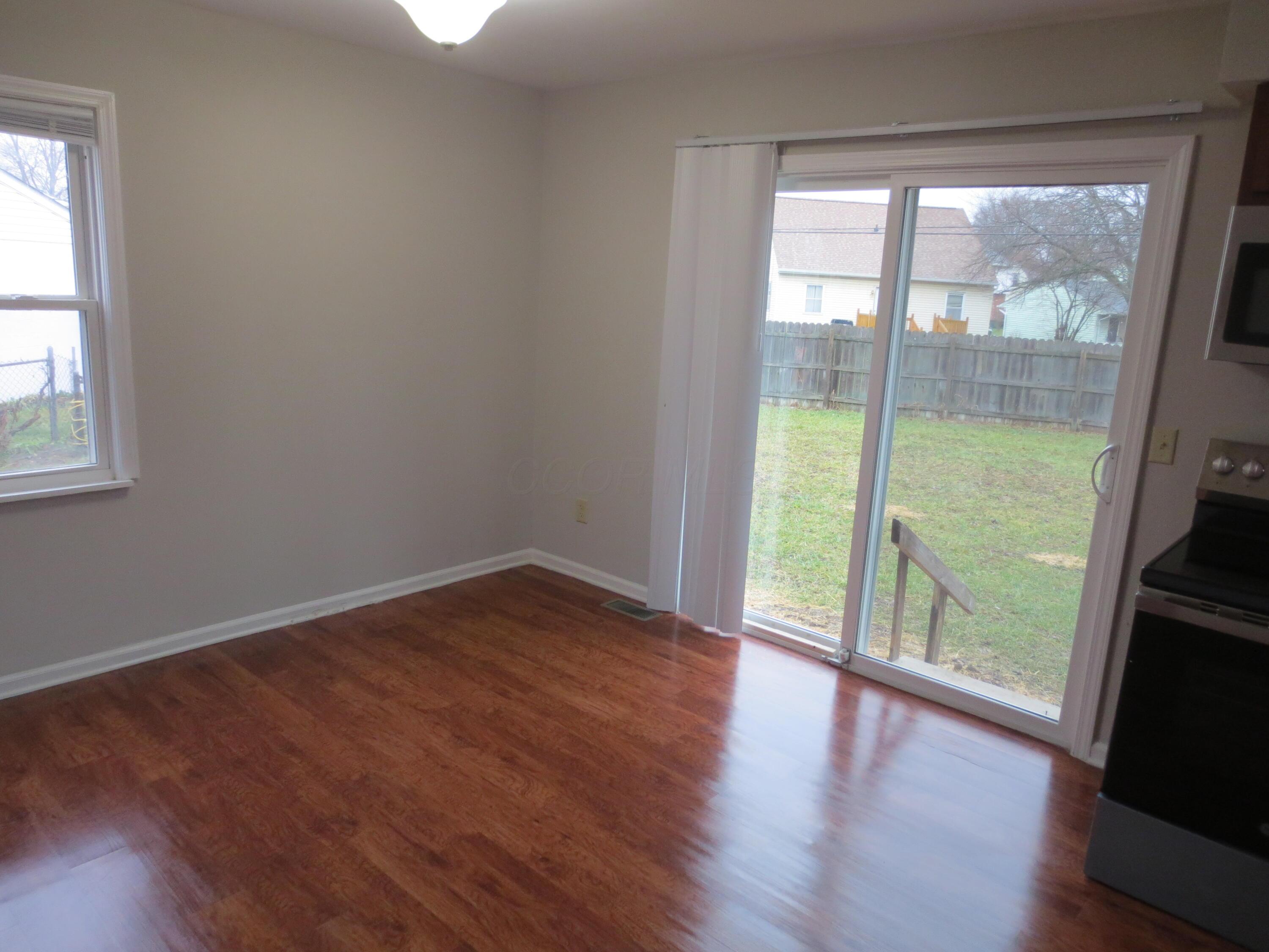 Dining area and sliding door and new blind.