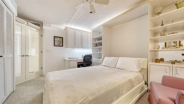 a bedroom with a bed and chair