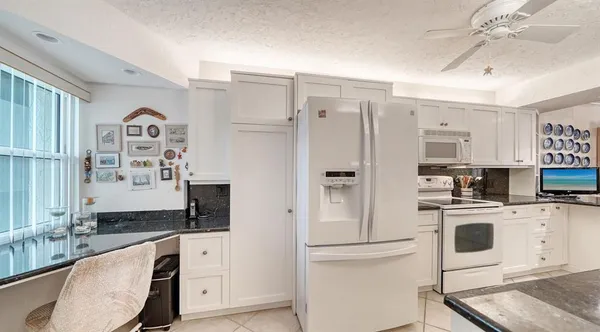 a kitchen with a sink and white cabinets