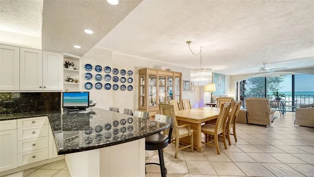 a view of a dining room with furniture and chandelier