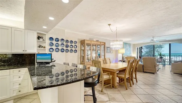 a view of a dining room with furniture and chandelier
