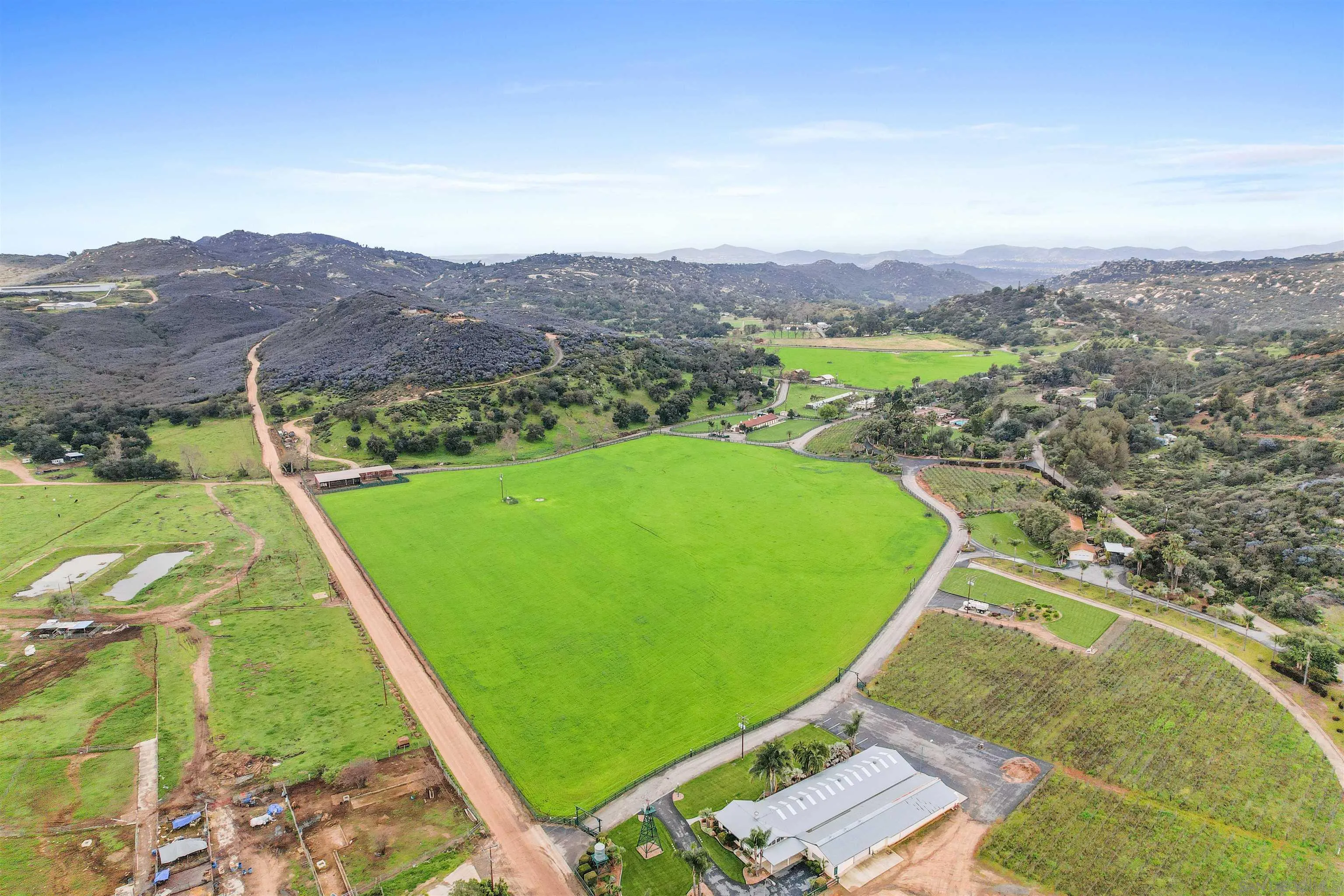 16757 Old Guejito Grade Road Escondido, CA 92027 - Photo 36 of 38 a view of a lush green hillside and a building