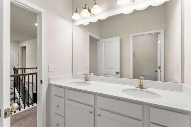 a bathroom with a sink vanity and a mirror