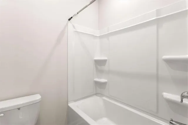 a bathroom with a bathtub and toilet