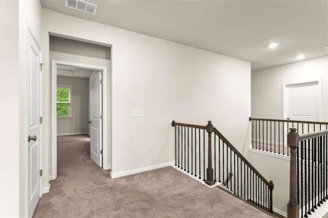a view of a hallway with a livingroom and a bathroom