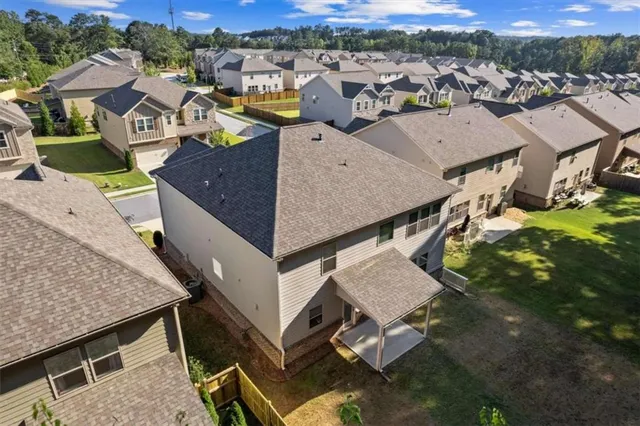 an aerial view of a house with swimming pool and mountains