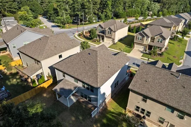 an aerial view of a house with swimming pool and outdoor seating