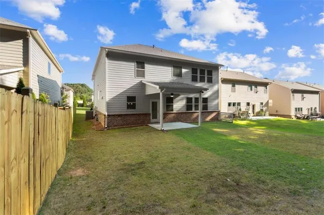 a view of an house with backyard porch and sitting area