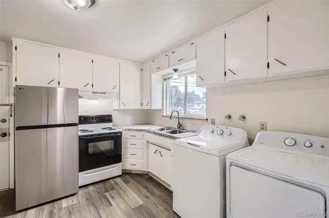 a view of a kitchen with sink and cabinets