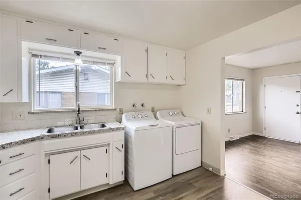 a view of a kitchen with sink and cabinets