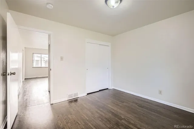a bedroom with a bed and a potted plant