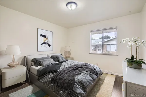 a bedroom with a bed and a potted plant
