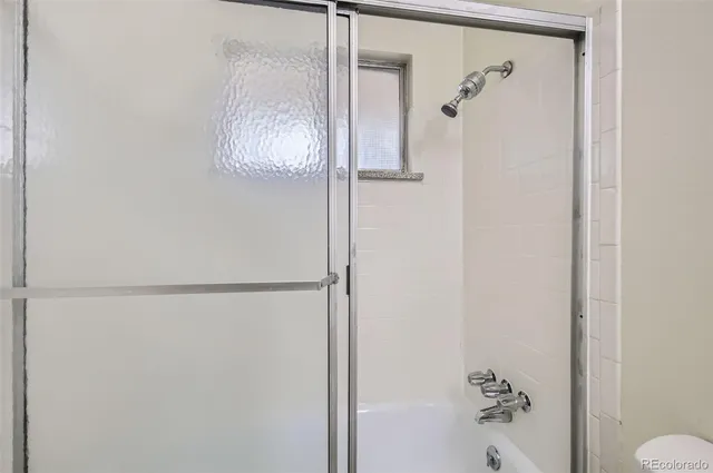 a bedroom with bed and a window