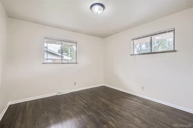 an empty room with wooden floor