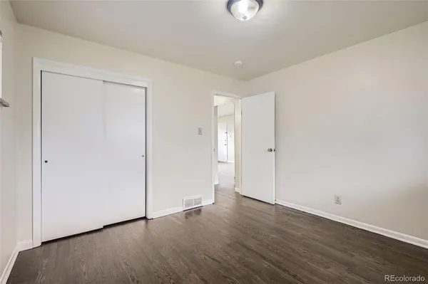 an empty room with wooden floor