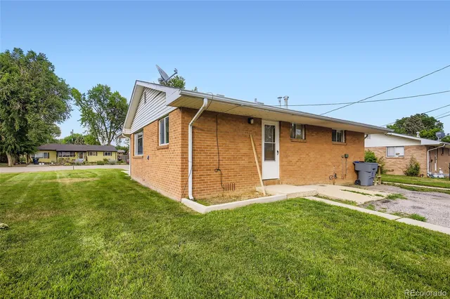 a front view of a house with a garden and yard