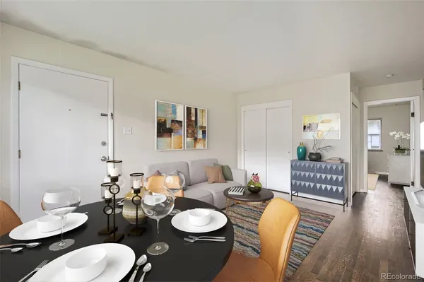 a dining room with furniture a rug and wooden floor