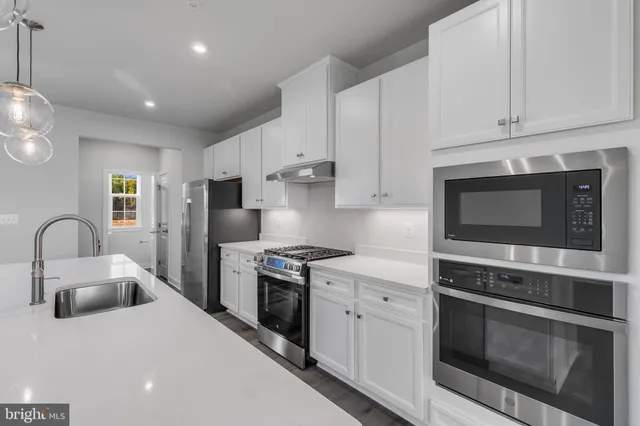 a large kitchen with stainless steel appliances kitchen island a large island in the center