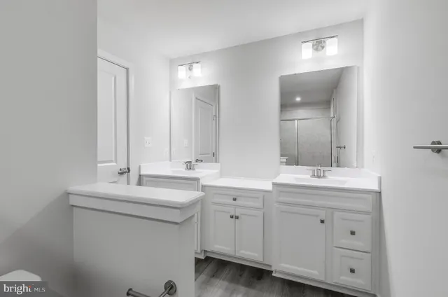 a spacious bathroom with a double vanity sink and a mirror