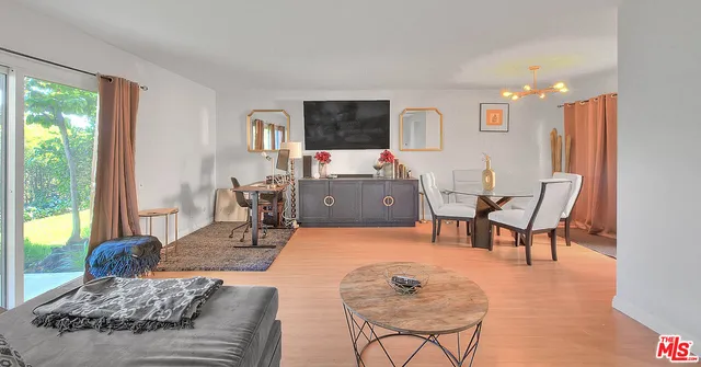 a view of a dining room with furniture window and wooden floor