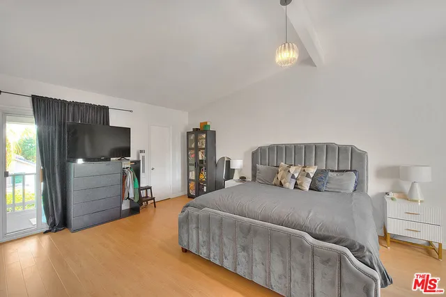 a view of white cabinets and a window