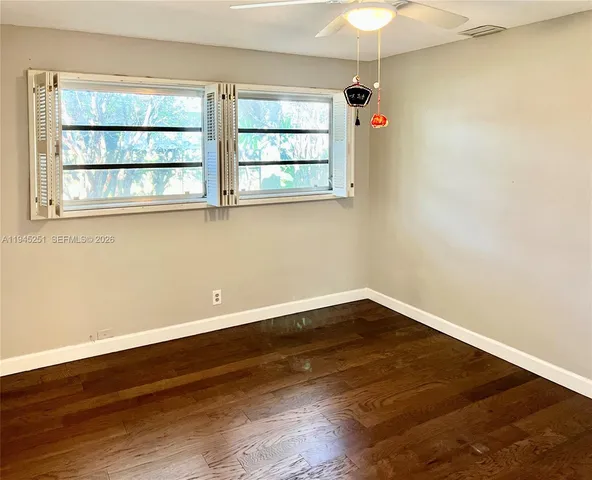 a front view of a house with a yard and a garden