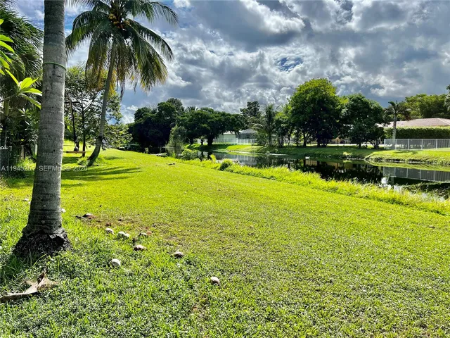 a view of a chair and table in backyard