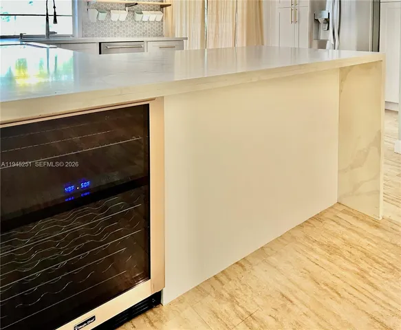 a view of a room with a window and wooden floor