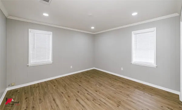 a bathroom with a toilet a sink a tub and mirror