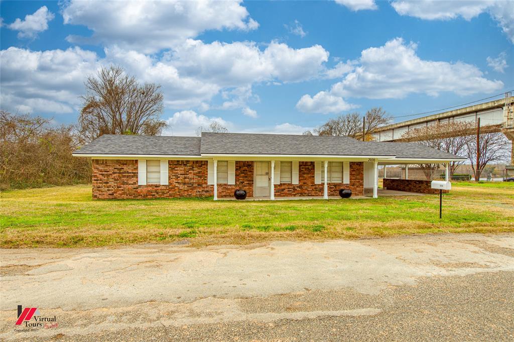 2036 Abney Street Coushatta, LA 71019 - Photo 20 of 32 a view of a house with a big yard and large trees