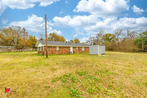 a backyard of a house with lots of green space and chair