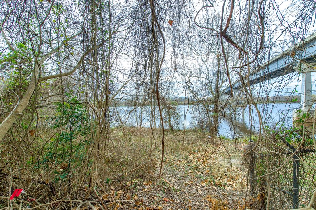 2036 Abney Street Coushatta, LA 71019 - Photo 24 of 32 a backyard of a house with lots of green space and chair