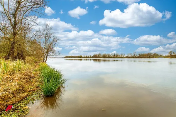 a view of a lake with houses in the back