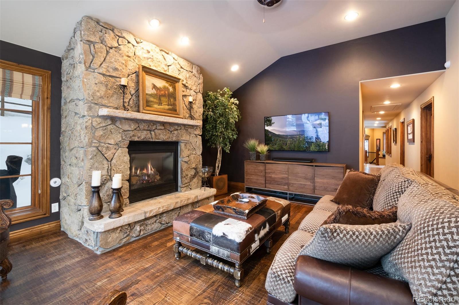 497 Meadow Vista Drive Evergreen, CO 80439 - Photo 13 of 40 a living room with furniture and a fireplace