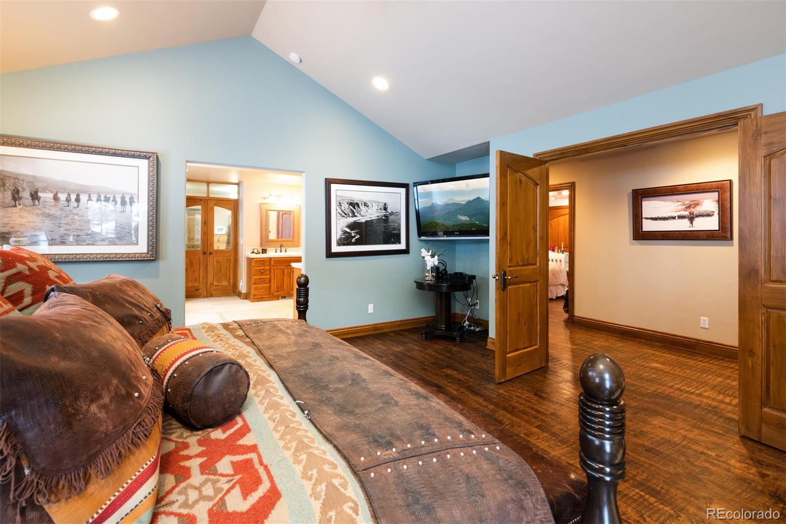 497 Meadow Vista Drive Evergreen, CO 80439 - Photo 18 of 40 a bedroom with a bed and wooden floor