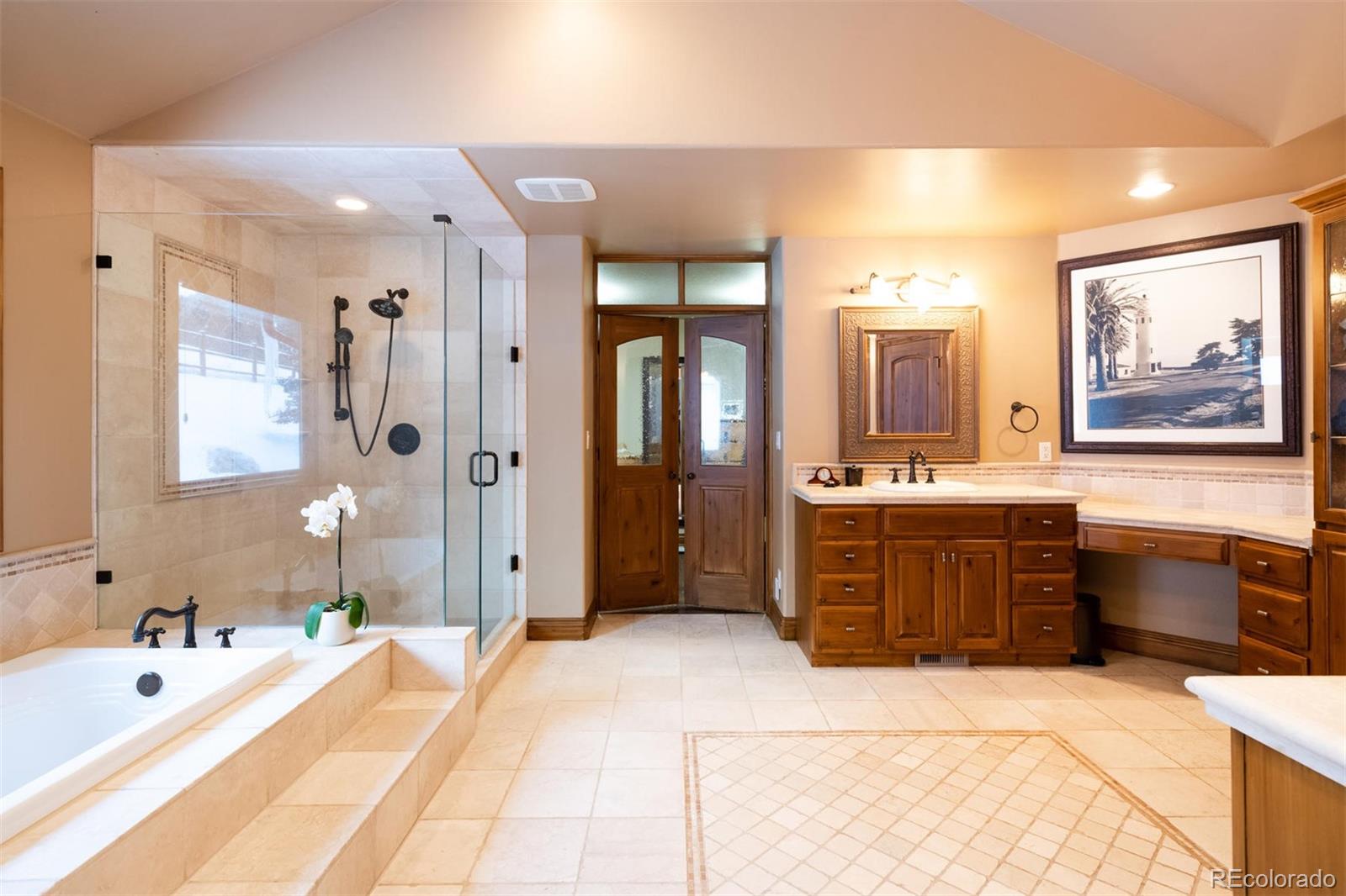 497 Meadow Vista Drive Evergreen, CO 80439 - Photo 19 of 40 a spacious bathroom with a tub sink and mirror