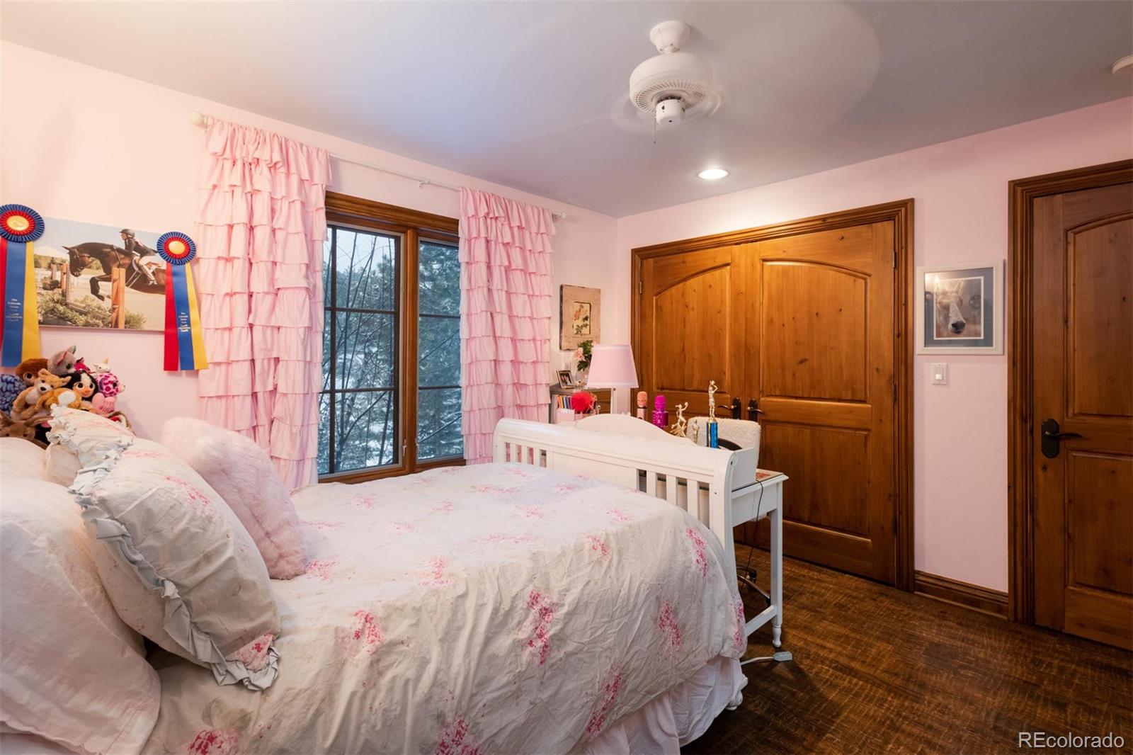 497 Meadow Vista Drive Evergreen, CO 80439 - Photo 22 of 40 a bedroom with a bed and a window