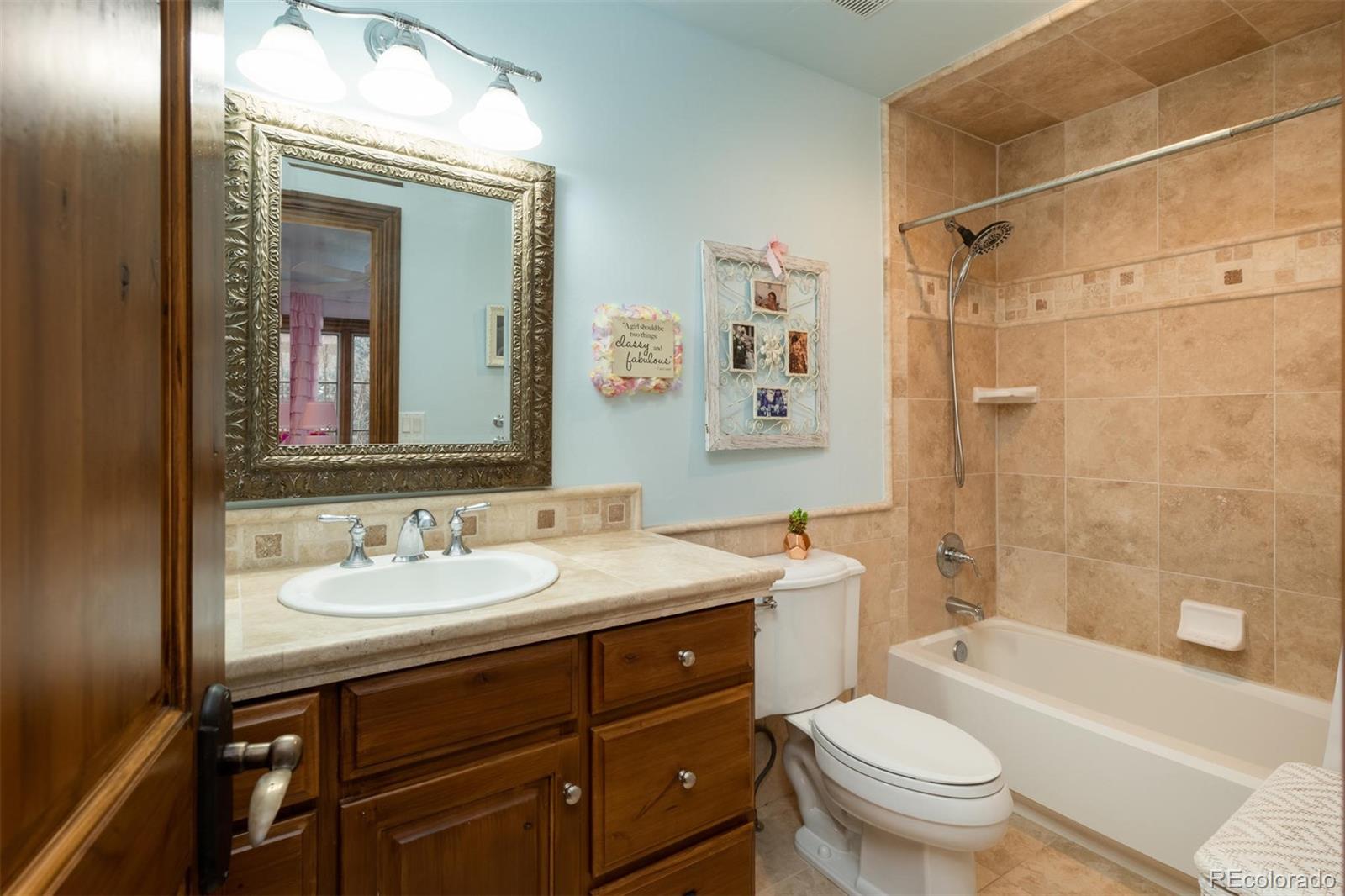 497 Meadow Vista Drive Evergreen, CO 80439 - Photo 23 of 40 a bathroom with a sink a toilet and shower