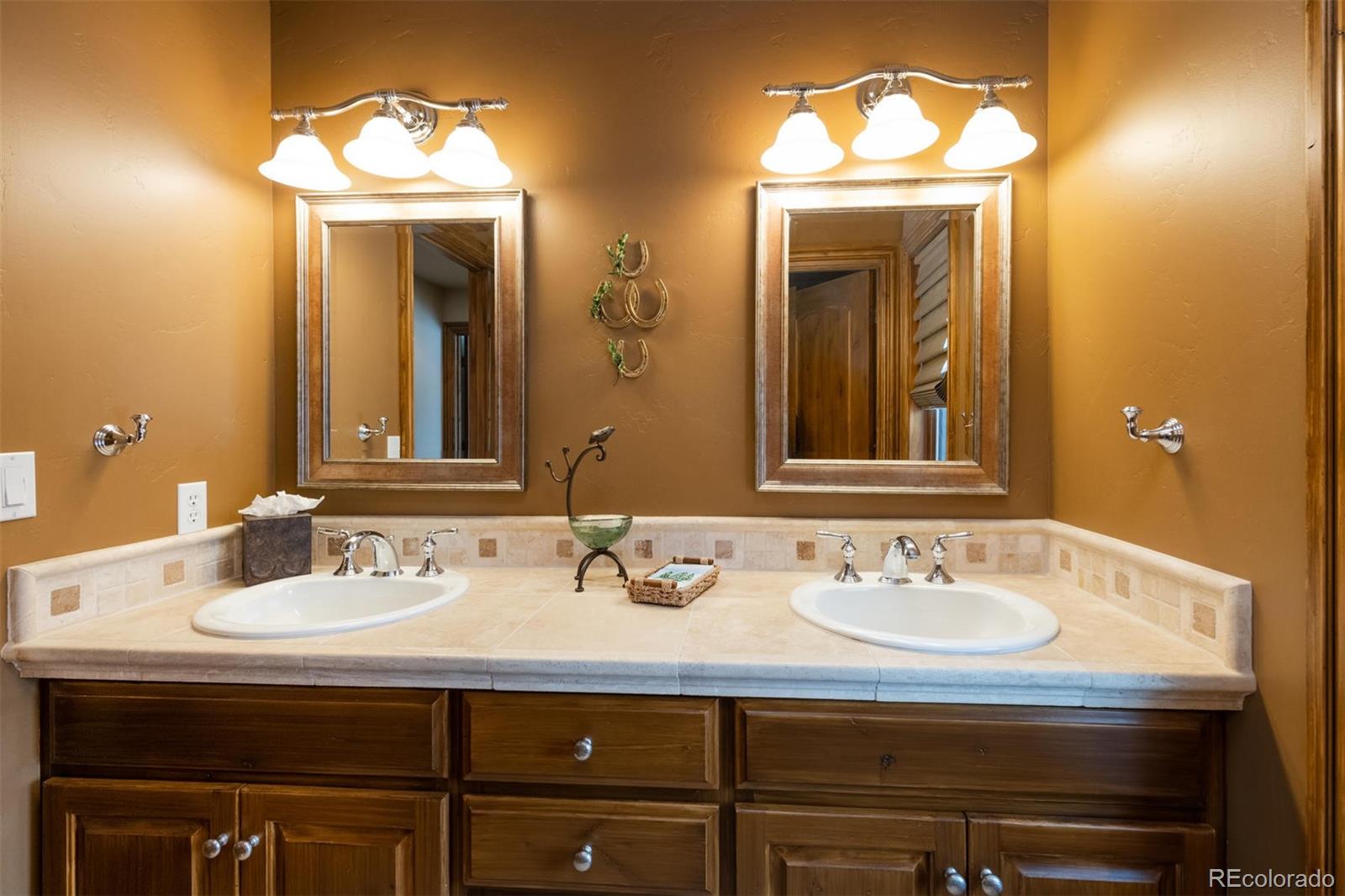 497 Meadow Vista Drive Evergreen, CO 80439 - Photo 25 of 40 a bathroom with a sink and a mirror