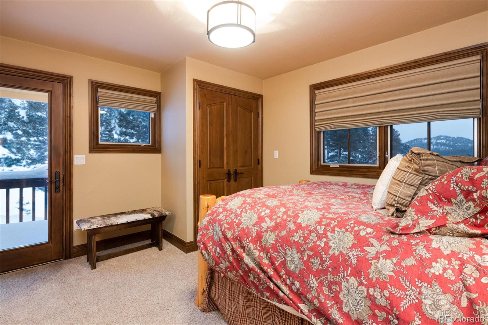 497 Meadow Vista Drive Evergreen, CO 80439 - Photo 36 of 40 a bedroom with a bed and a window