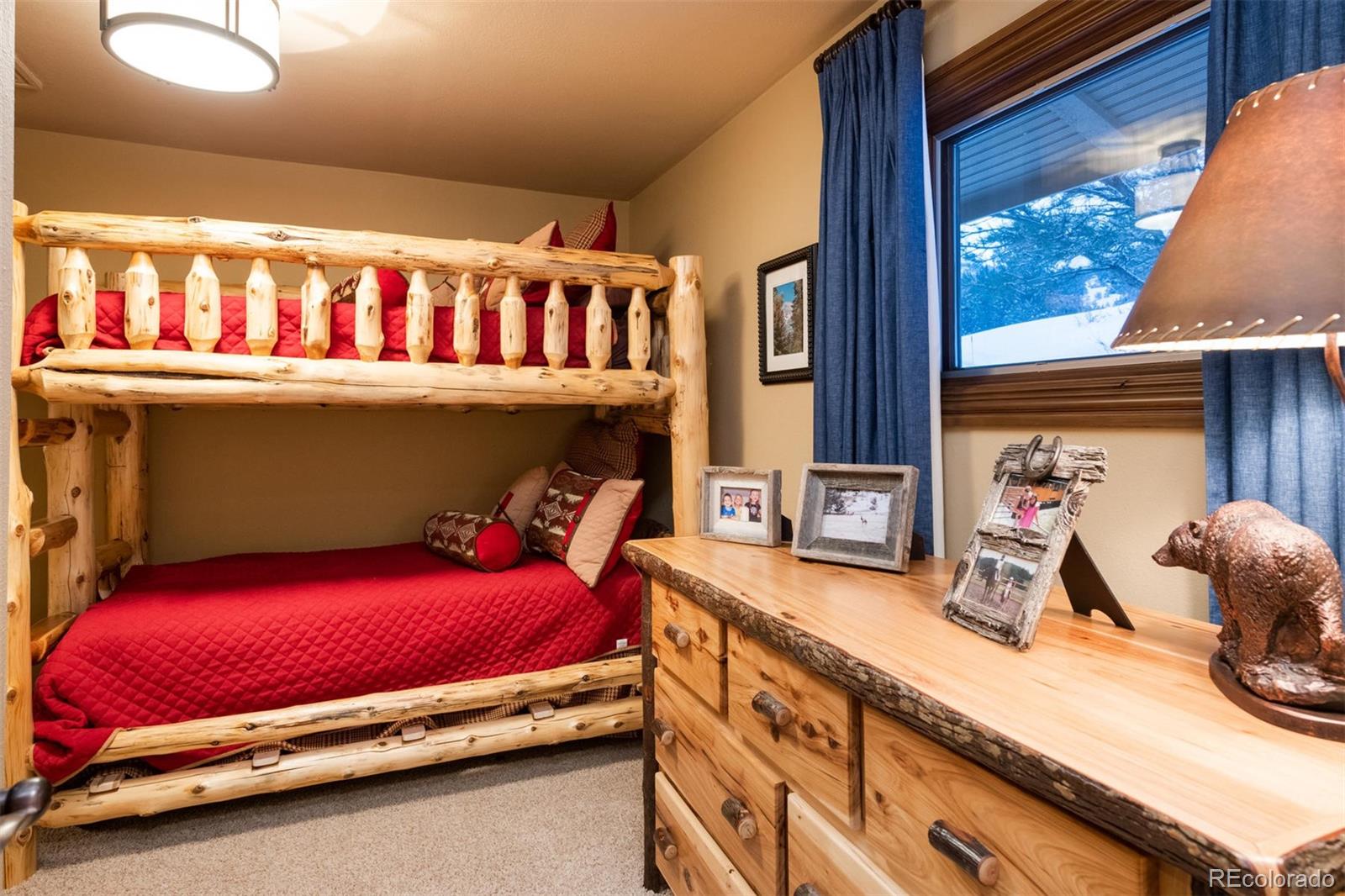 497 Meadow Vista Drive Evergreen, CO 80439 - Photo 37 of 40 a room with furniture and a flat screen tv