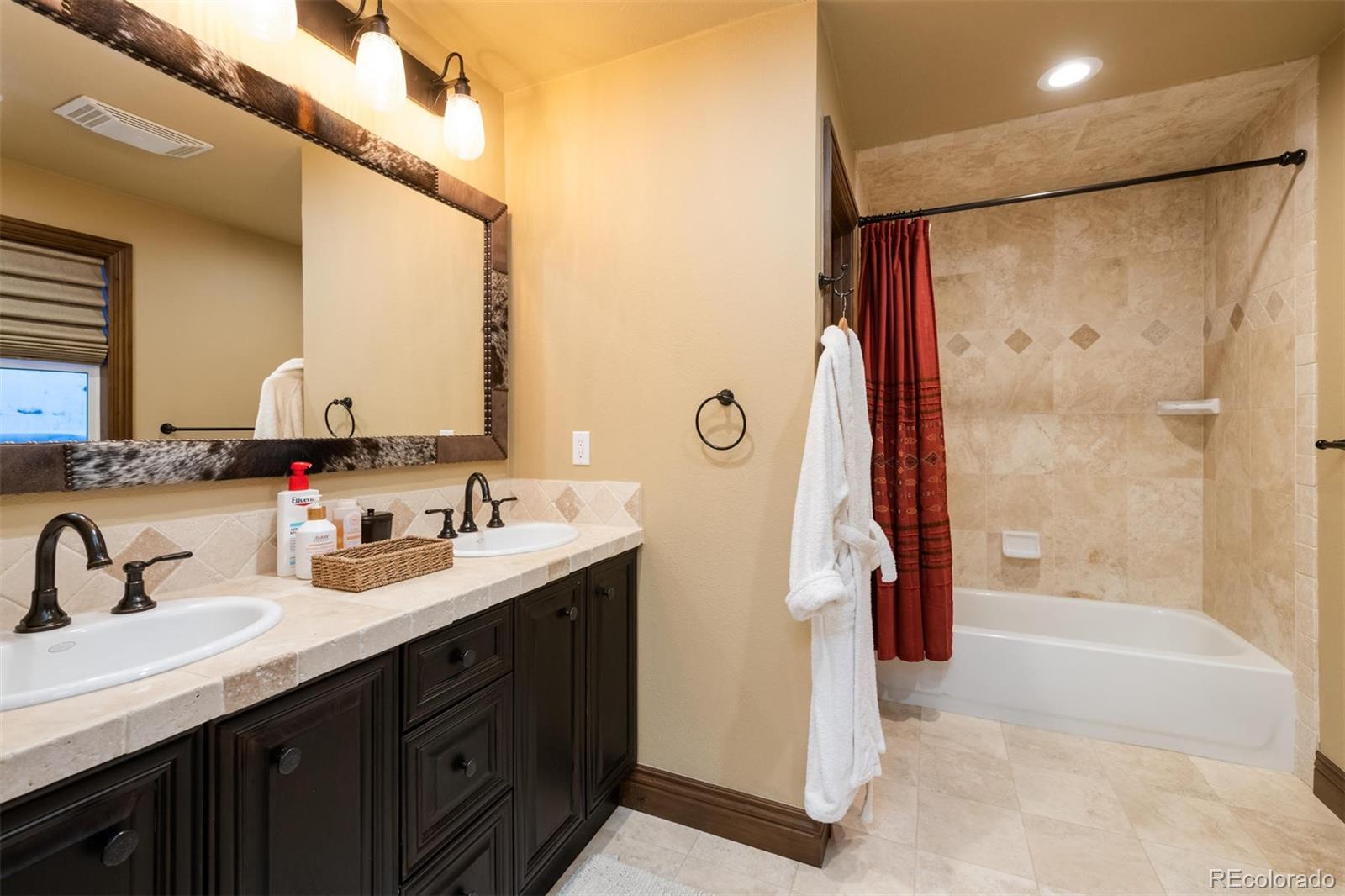 497 Meadow Vista Drive Evergreen, CO 80439 - Photo 38 of 40 a bathroom with a double vanity sink mirror and shower