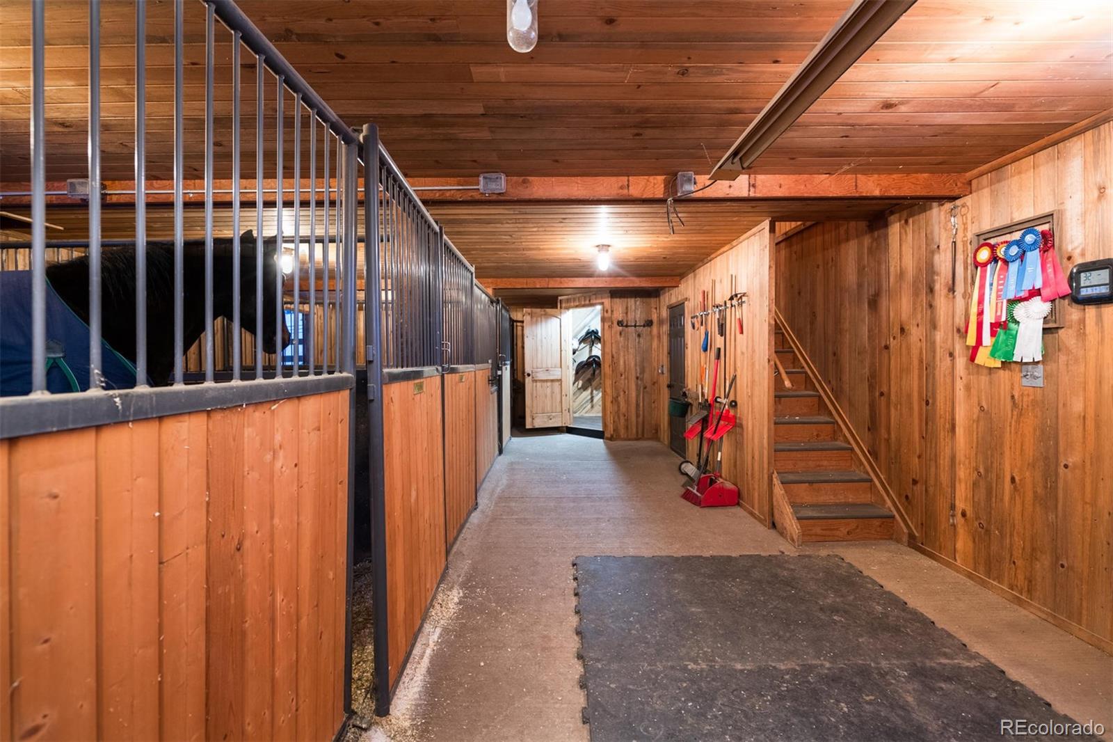 497 Meadow Vista Drive Evergreen, CO 80439 - Photo 39 of 40 a view of a hallway with wooden stairs