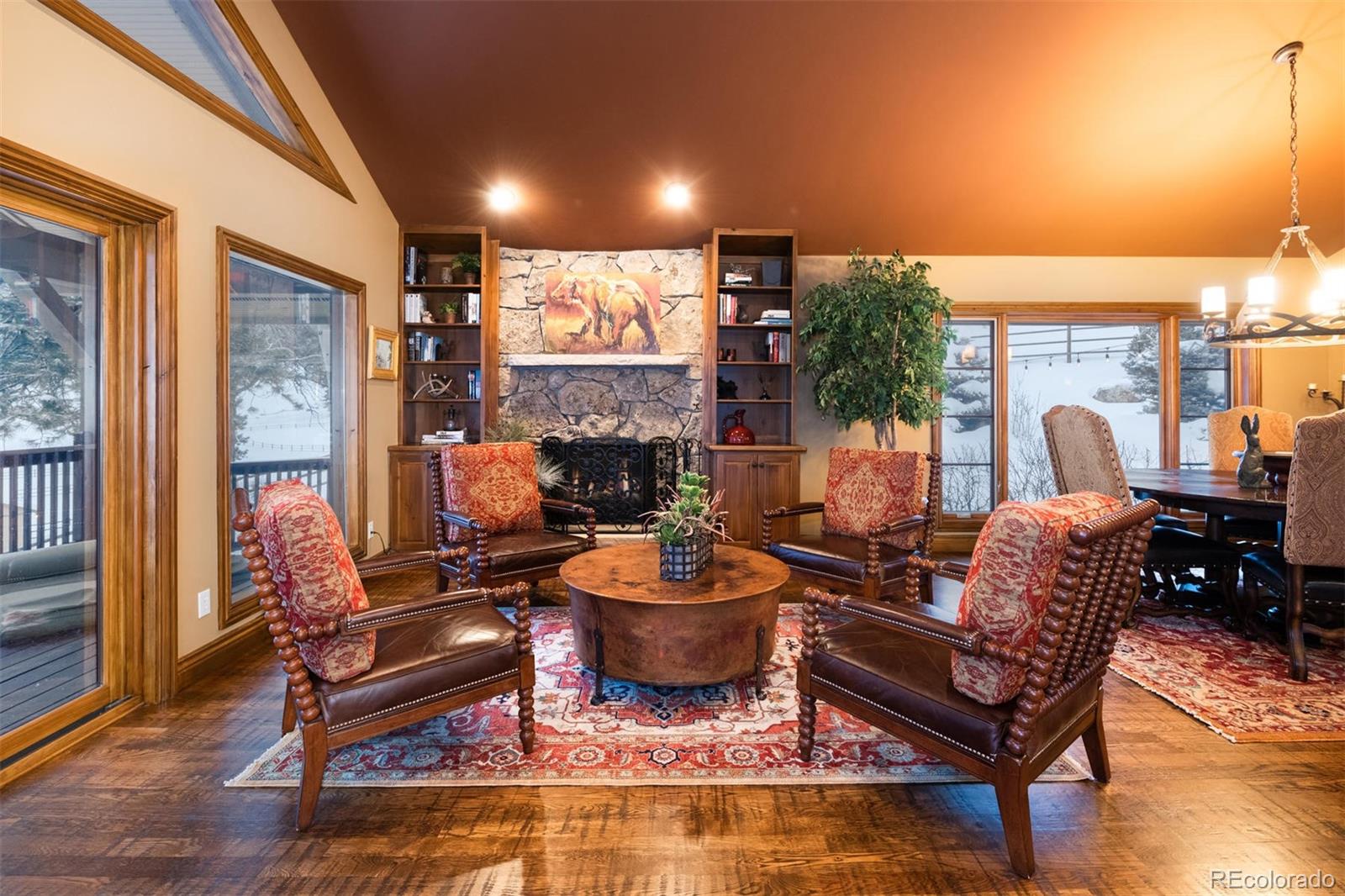 497 Meadow Vista Drive Evergreen, CO 80439 - Photo 5 of 40 a living room with furniture a fireplace and a potted plant