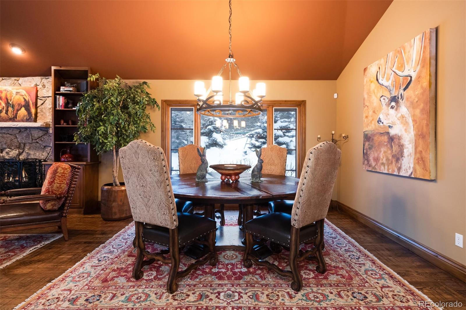 497 Meadow Vista Drive Evergreen, CO 80439 - Photo 8 of 40 a view of a dining room with furniture window and wooden floor