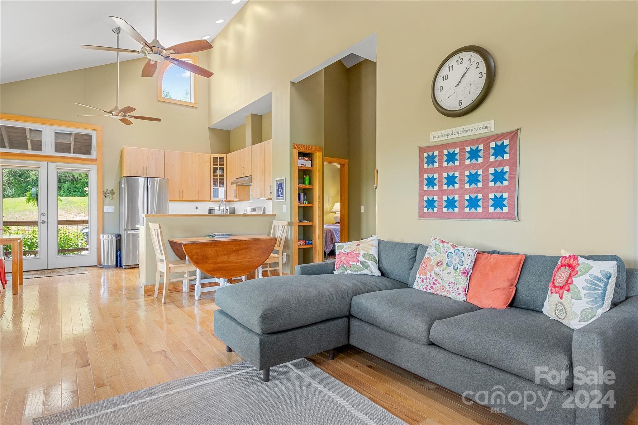 329 Cabin Hollow Drive Marshall, NC 28753 - Photo 12 of 40 a living room with furniture a clock on a wall and a large window