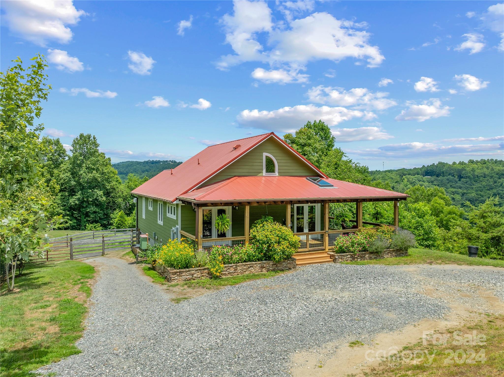 329 Cabin Hollow Drive Marshall, NC 28753 - Photo 32 of 40 a view of a patio with table and chairs under an umbrella